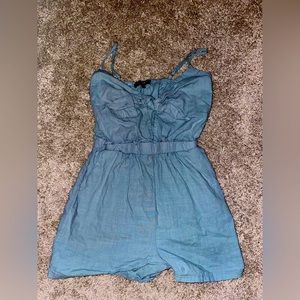 Blue spaghetti strap jumpsuit with a bow in front